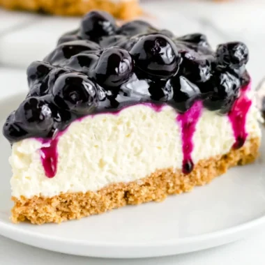 No bake blueberry cheesecake topped with fresh blueberries and whipped cream