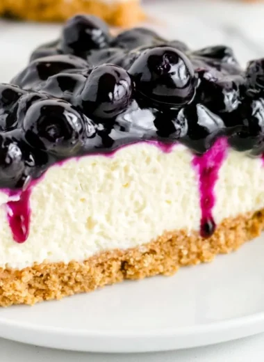 No bake blueberry cheesecake topped with fresh blueberries and whipped cream