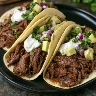 Delicious Mexican shredded beef tacos made in a cozy crock pot