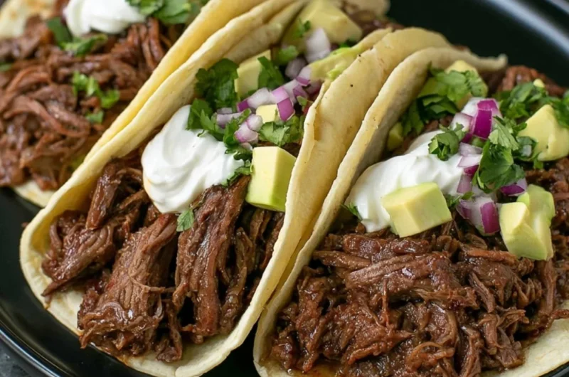 Delicious Mexican shredded beef tacos made in a cozy crock pot