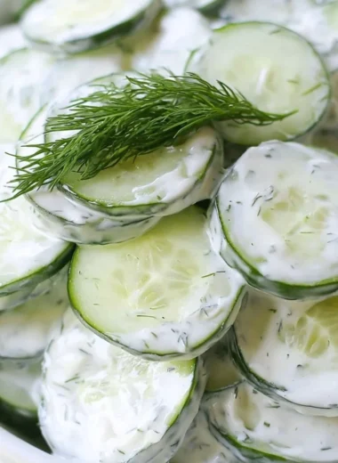 Creamy cucumber salad with onions and tangy sour cream dressing