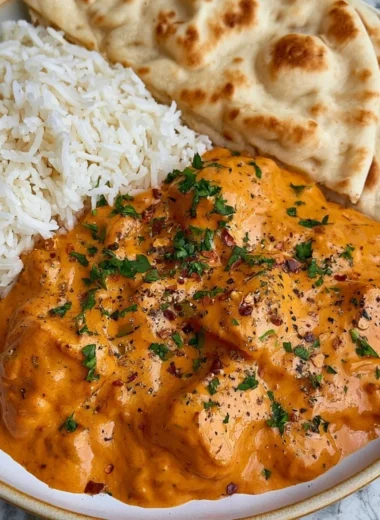 Delicious homemade butter chicken served with rice and naan bread