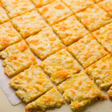 Cozy homemade sourdough crackers topped with cheddar cheese