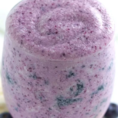 Healthy blueberry banana protein smoothie in a glass with fresh fruits