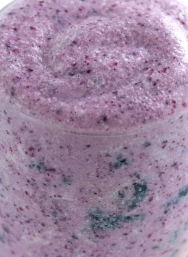 Healthy blueberry banana protein smoothie in a glass with fresh fruits