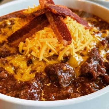 Bowl of no-bean carnivore chili topped with herbs and spices