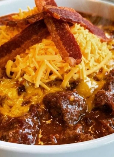 Bowl of no-bean carnivore chili topped with herbs and spices