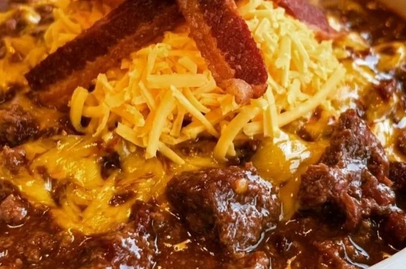Bowl of no-bean carnivore chili topped with herbs and spices