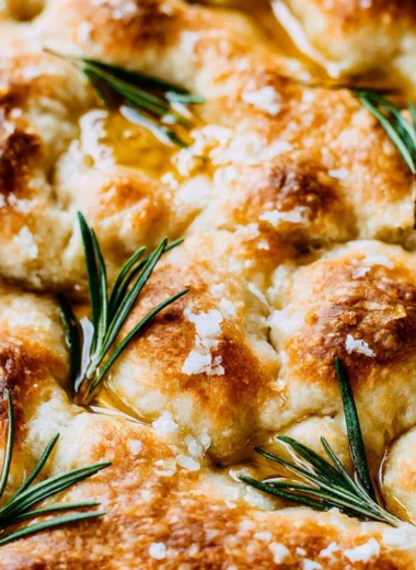 Freshly baked same day sourdough focaccia bread on a wooden board