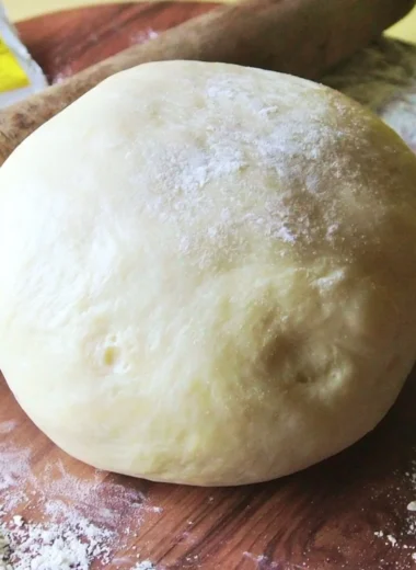Homemade Italian pizza dough rising in a bowl