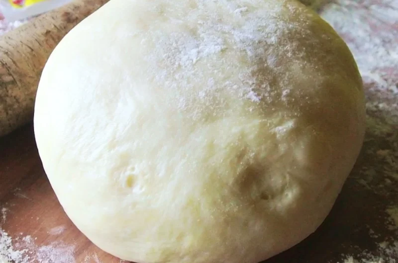 Homemade Italian pizza dough rising in a bowl