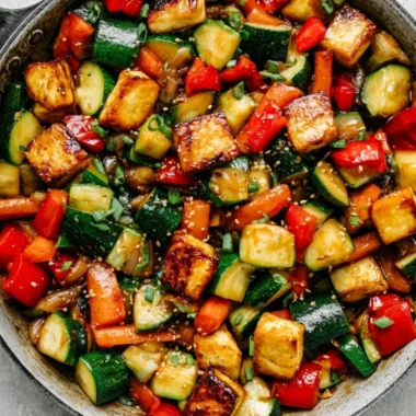Delicious zucchini stir fry with tofu served in a colorful bowl.