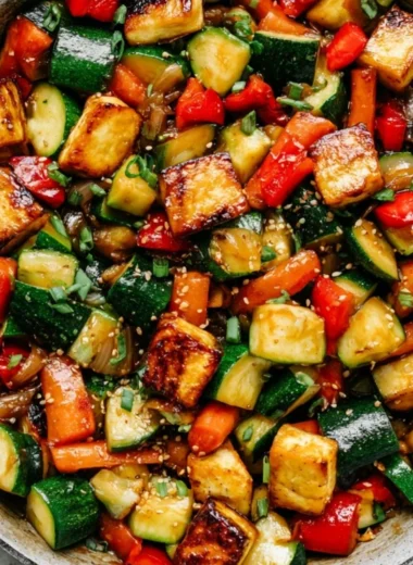 Delicious zucchini stir fry with tofu served in a colorful bowl.