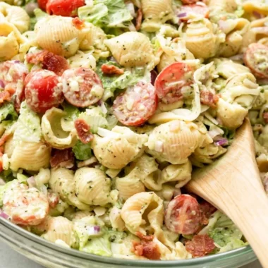 Colorful BLT Pasta Salad with bacon, lettuce, and tomatoes in a bowl.