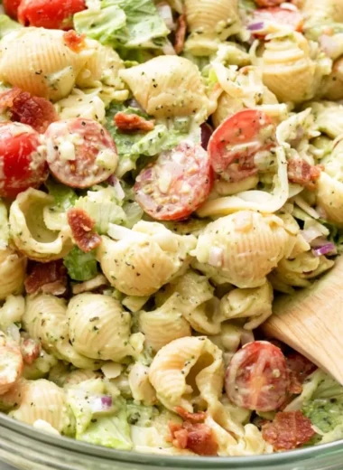 Colorful BLT Pasta Salad with bacon, lettuce, and tomatoes in a bowl.